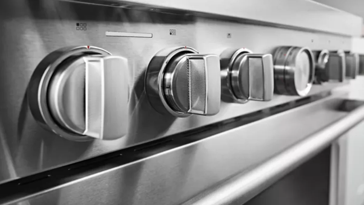 Close-up detail of KitchenAid KFDC506JSS professional-grade control knobs and stainless steel front panel