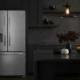 Frigidaire FRFG1723AV counter-depth refrigerator in modern dark kitchen showing sleek integration with black cabinetry and contemporary design