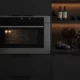 Wolf CSO30TM-S-TH 30-inch convection steam oven installed in dark modern luxury kitchen with warm accent lighting