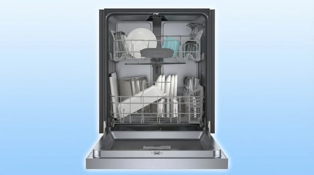 Bosch 100 Series dishwasher interior showing two-rack configuration with loaded dishes and cutlery holder
