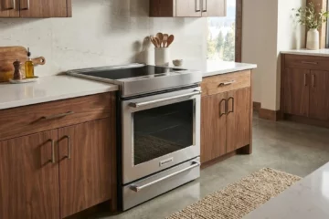 Stainless steel induction range in a warm modern kitchen
