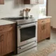 Stainless steel induction range in a warm modern kitchen