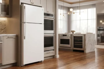 White GE GTS18HGNRWW top-freezer refrigerator in a luxury appliance showroom