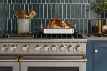 Roast turkey in a pan on a stainless steel Viking range in a blue-green kitchen