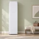 White LG S3WFBN Styler beside a linen bench against a sage wall in a sunlit dressing room