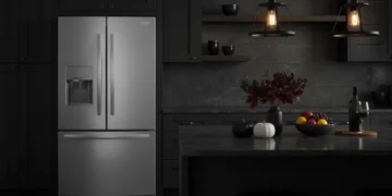 frigidaire-frfg1723av-modern-kitchen-lifestyle Frigidaire FRFG1723AV counter-depth refrigerator in modern dark kitchen showing sleek integration with black cabinetry and contemporary design